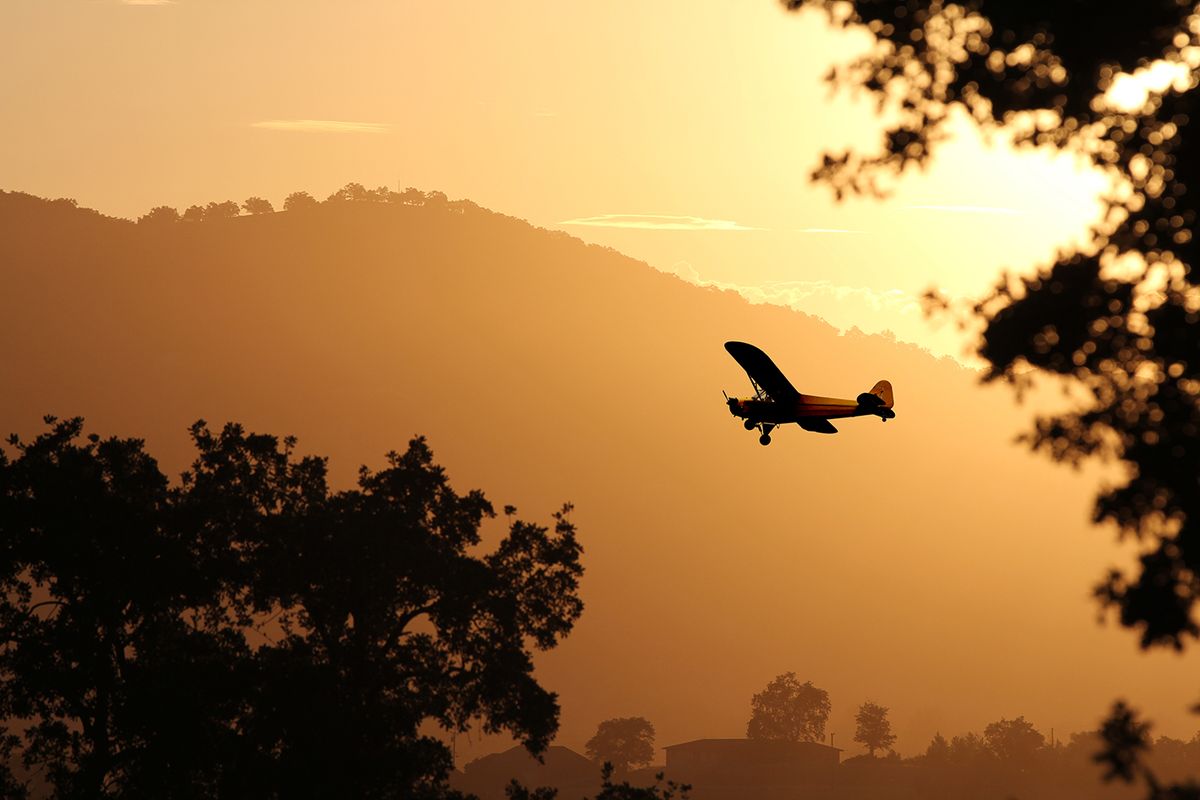 A,Small,Airplane,Flying,Through,The,Golden,Yellow,Mountains,Preparing