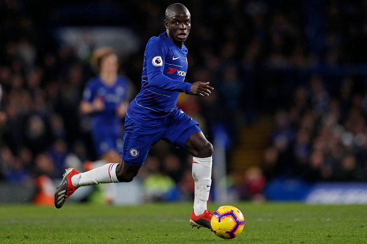 Chelsea's French midfielder N'Golo Kante runs with the ball during the English Premier League football match between Chelsea and Newcastle United at Stamford Bridge in London on January 12, 2019. Chelsea won the game 2-1. (Photo by Adrian DENNIS / AFP) / RESTRICTED TO EDITORIAL USE. No use with unauthorized audio, video, data, fixture lists, club/league logos or 'live' services. Online in-match use limited to 120 images. An additional 40 images may be used in extra time. No video emulation. Social media in-match use limited to 120 images. An additional 40 images may be used in extra time. No use in betting publications, games or single club/league/player publications. /