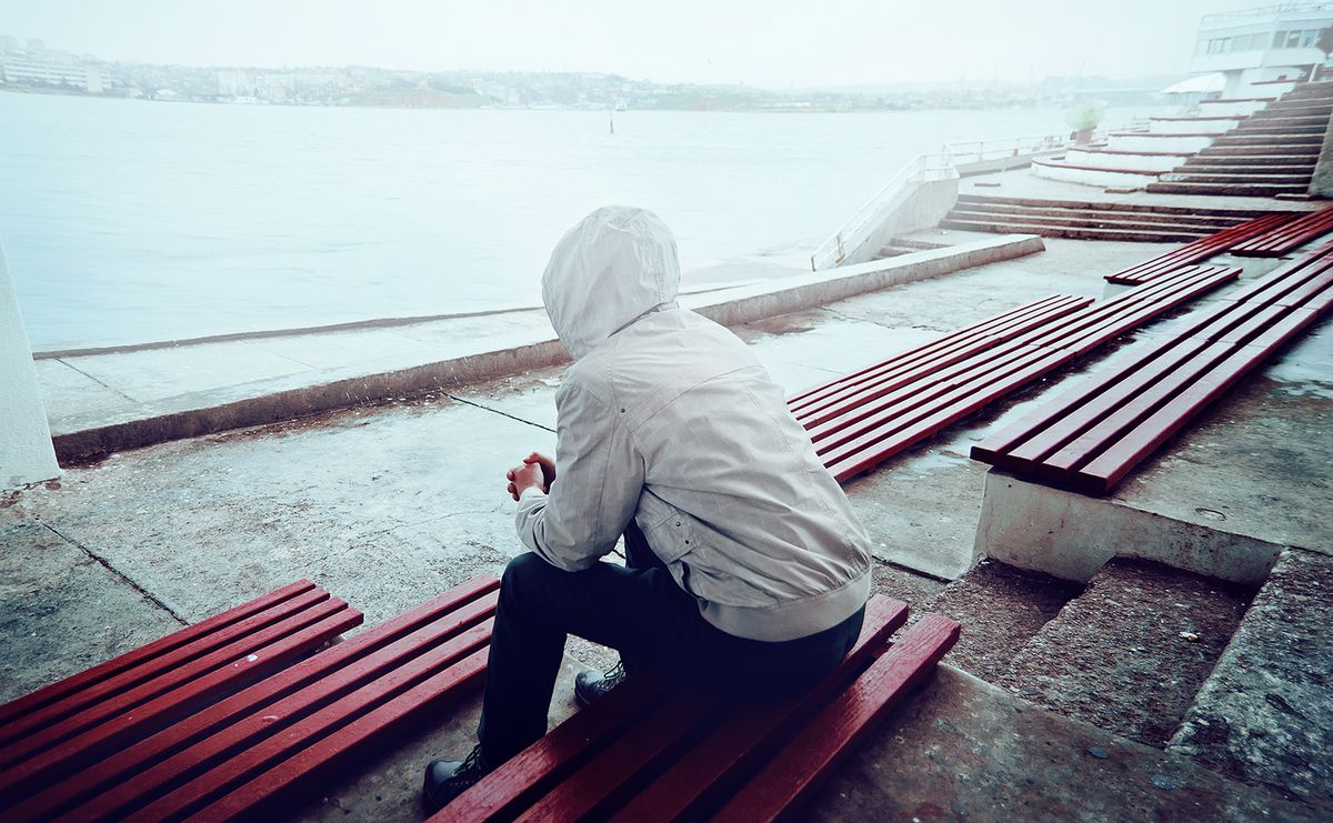 Young,Man,Sitting,On,The,Promenade,On,A,Cloudy,Day
young man sitting on the promenade on a cloudy day
