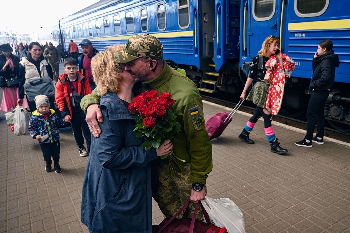UKRAINE-RUSSIA-COFLICT-WARA woman embraces her husband, a Ukrainian serviceman, as he arrives by train to the railway station of the western Ukrainian city of Lviv on April 20, 2023, amid Russia's miltary invasion on Ukraine. (Photo by YURIY DYACHYSHYN / AFP)