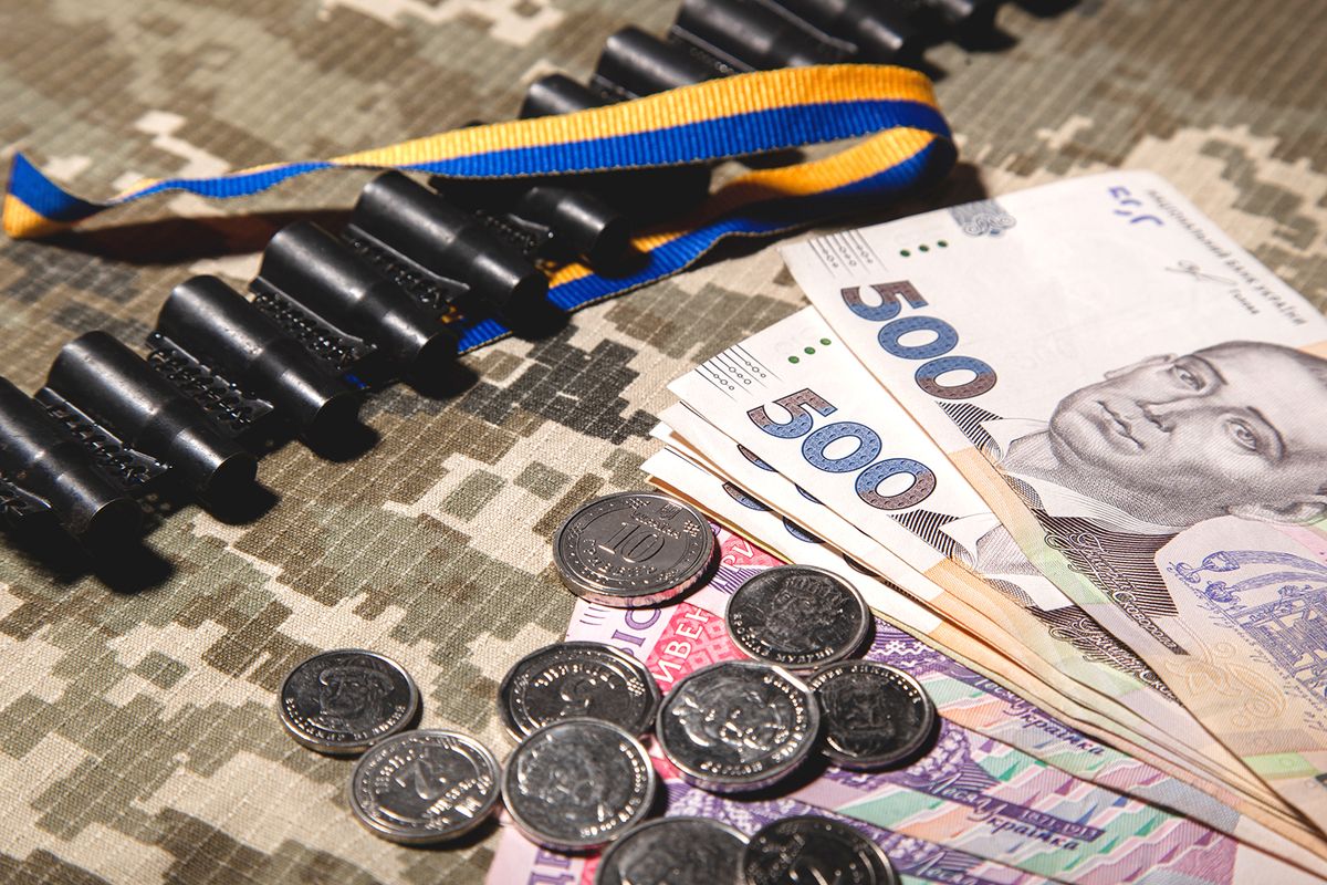 Banknotes,Of,500,Hryvnia,And,Coins,With,A,Face,Value, Banknotes of 500 hryvnia and coins with a face value of 10 hryvnia and others, machine gun tape and blue-yellow on the background of a military pixel. Ukrainian hryvnia. Money of Ukraine.