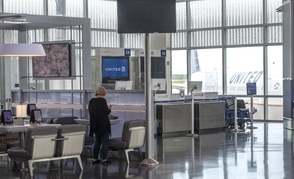 A woman stands near a table in an empty terminal at the George Bush Intercontinental in Houston, Texas on June 10, 2020, during the coronavirus pandemic. (Photo by ANDREW CABALLERO-REYNOLDS / AFP)