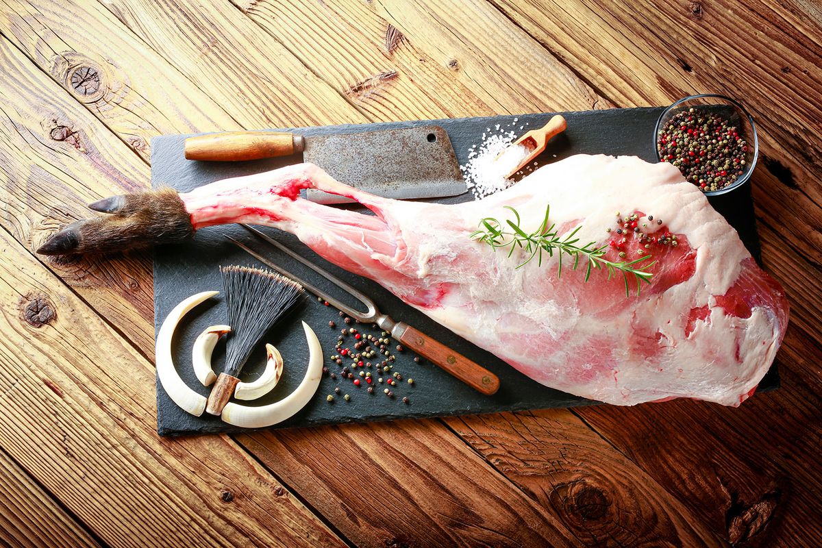 vaddisznó, vadhús,
Detail,Of,Raw,Meat,,Thigh,Of,Wild,Boar,On,A
Detail of raw meat, thigh of wild boar on a black plate with rosemary, salt and pepper. the atmosphere of hunting is completed by weapons from wild boar