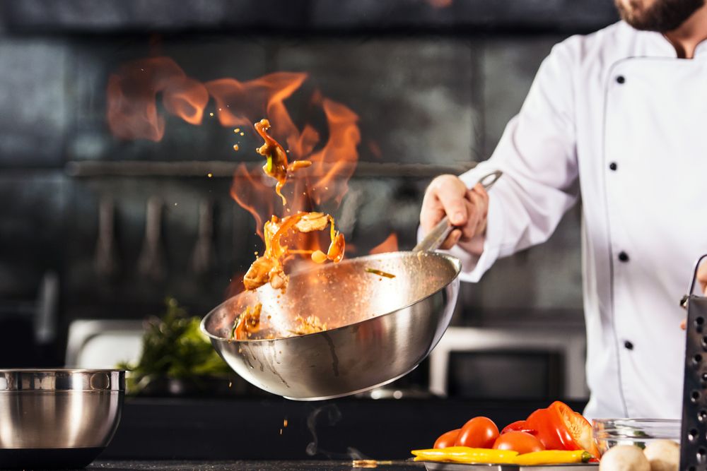 Chef,Hands,Keep,Wok,With,Fire.,Closeup,Chef,Hands,Cook