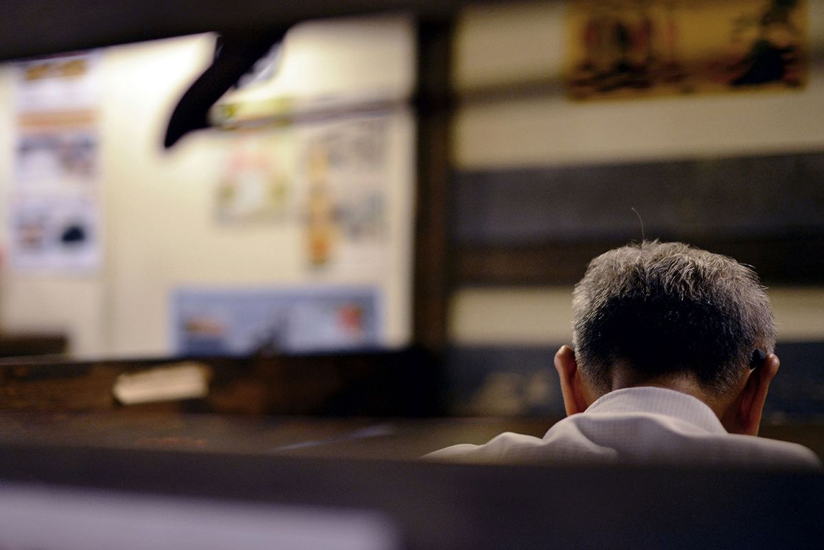 Elderl,Sitting,Alone,In,A,Restaurant,In,Singapore.