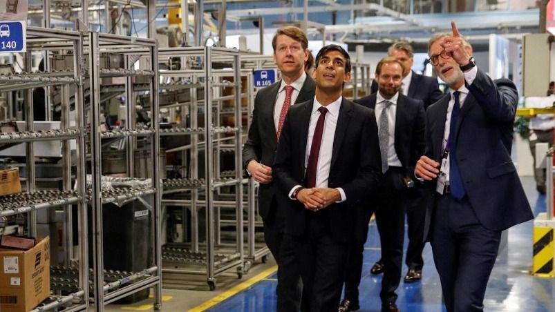 Chancellor of the Exchequer Rishi Sunak (C) speaks with CEO of Worcester Bosch, Carl Arntzen (R) during a visit to the Worcester Bosch factory in Worcester, central England, on July 9, 2020. The UK government on on July 8 committed £30 billion ($37 billion, 33 billion euros) to saving jobs and helping the young find work in an economy ravaged by the coronavirus pandemic. Delivering a mini-budget to parliament, finance minister Rishi Sunak announced bonuses to companies retaining staff and taking on apprentices, investment in eco-friendly jobs and even allowing Britons to enjoy discounted meals in some restaurants. (Photo by PHIL NOBLE / POOL / AFP)