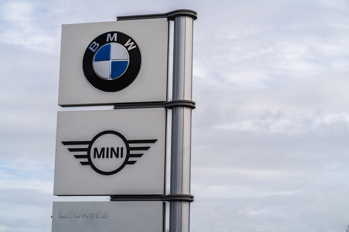 Bmw,And,Mini,Logo,Signage,Against,Grey,Sky,With,Clouds