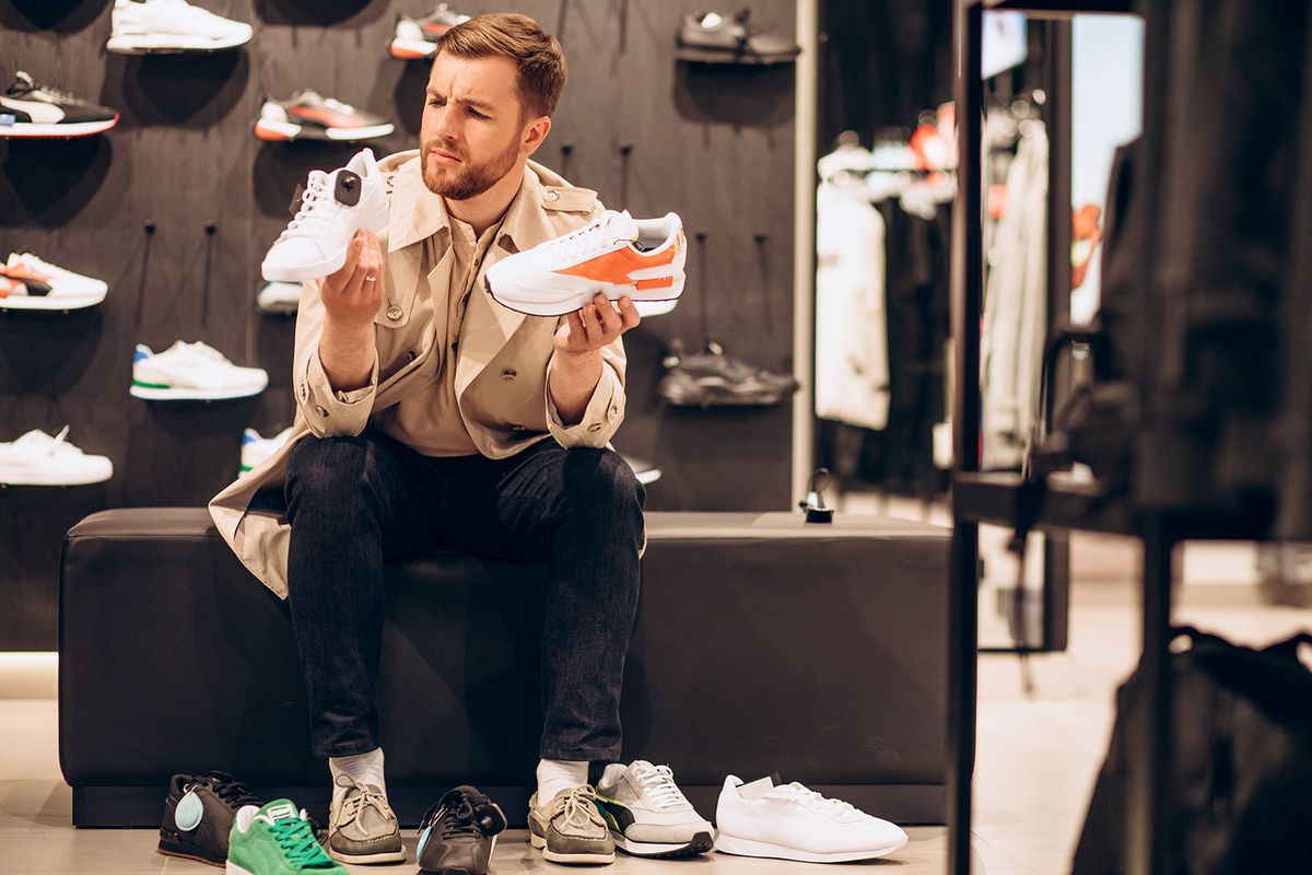 Young,Man,Choosing,Sneakers,At,Sportwear,Shop
Young man choosing sneakers at sportwear shop