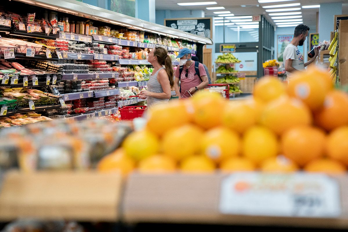 Shoppers walk through a grocery store in Washington, DC, on June 14, 2022. (Photo by Stefani Reynolds / AFP)