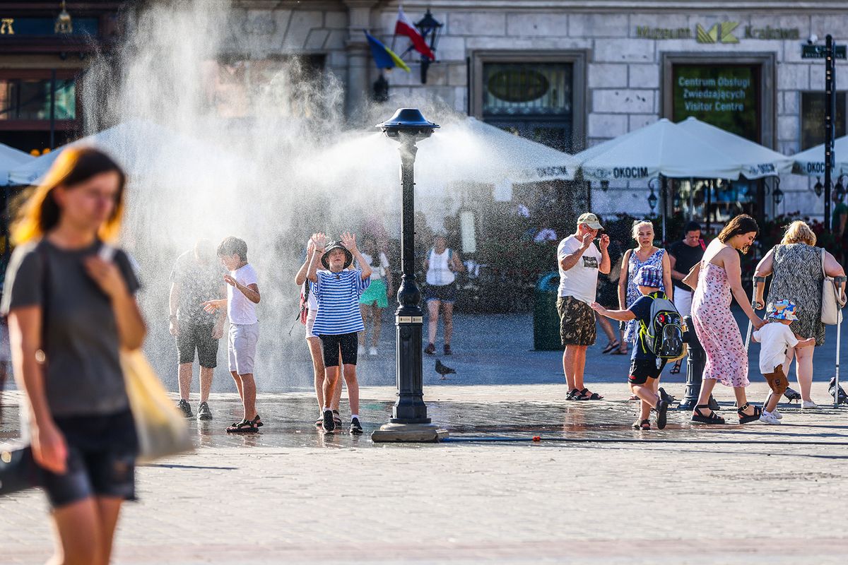 Heat Wave In Poland
Tourists are cooling by a water sprinkler at the Main Square in Krakow, Poland on July 25, 2022. Hot air masses from over Africa covered most of the country. (Photo by Beata Zawrzel/NurPhoto) (Photo by Beata Zawrzel / NurPhoto / NurPhoto via AFP)
