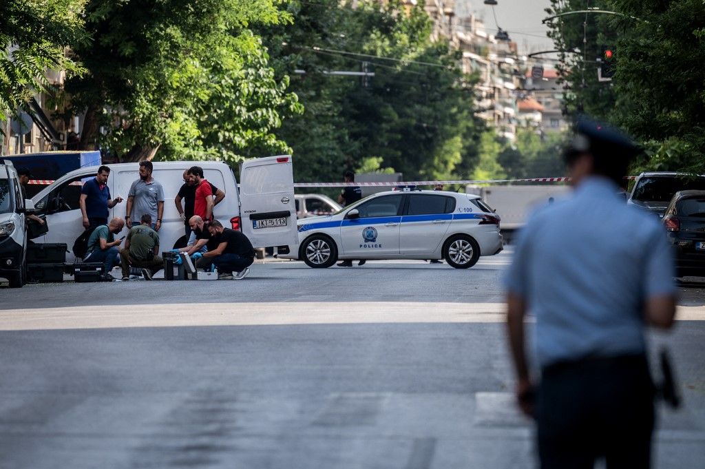 Greek police experts search for evidence after two incendiary devices exploded on the morning outside the Grand Lodge of Freemasons in central Athens on July 13, 2023. The explosions caused some material damage but no casualties, the Greek police announced on July 13, 2023. (Photo by Angelos Tzortzinis / AFP)