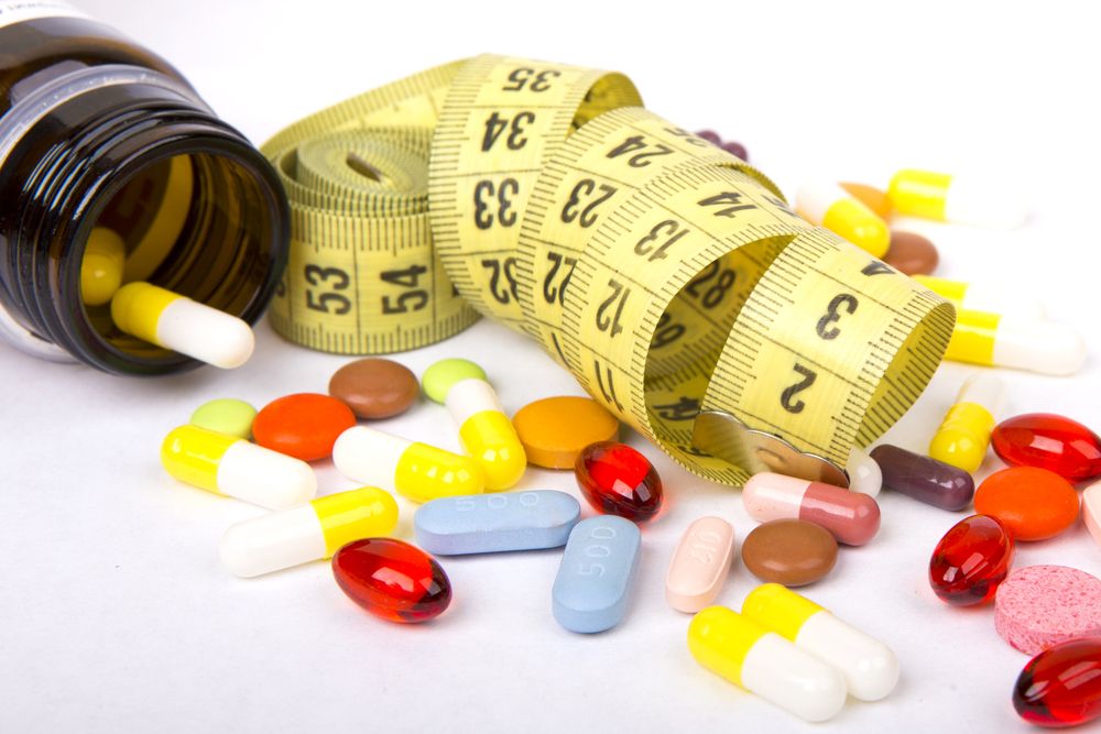 Measuring,Tape,And,Pills,For,Dieting,Concept
