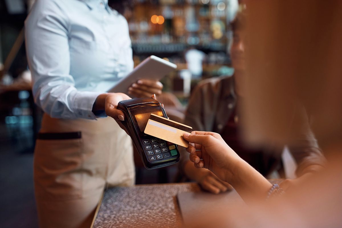 Close,Up,Of,Customer,Paying,With,Credit,Card,In,A
Close up of customer paying with credit card in a restaurant.
