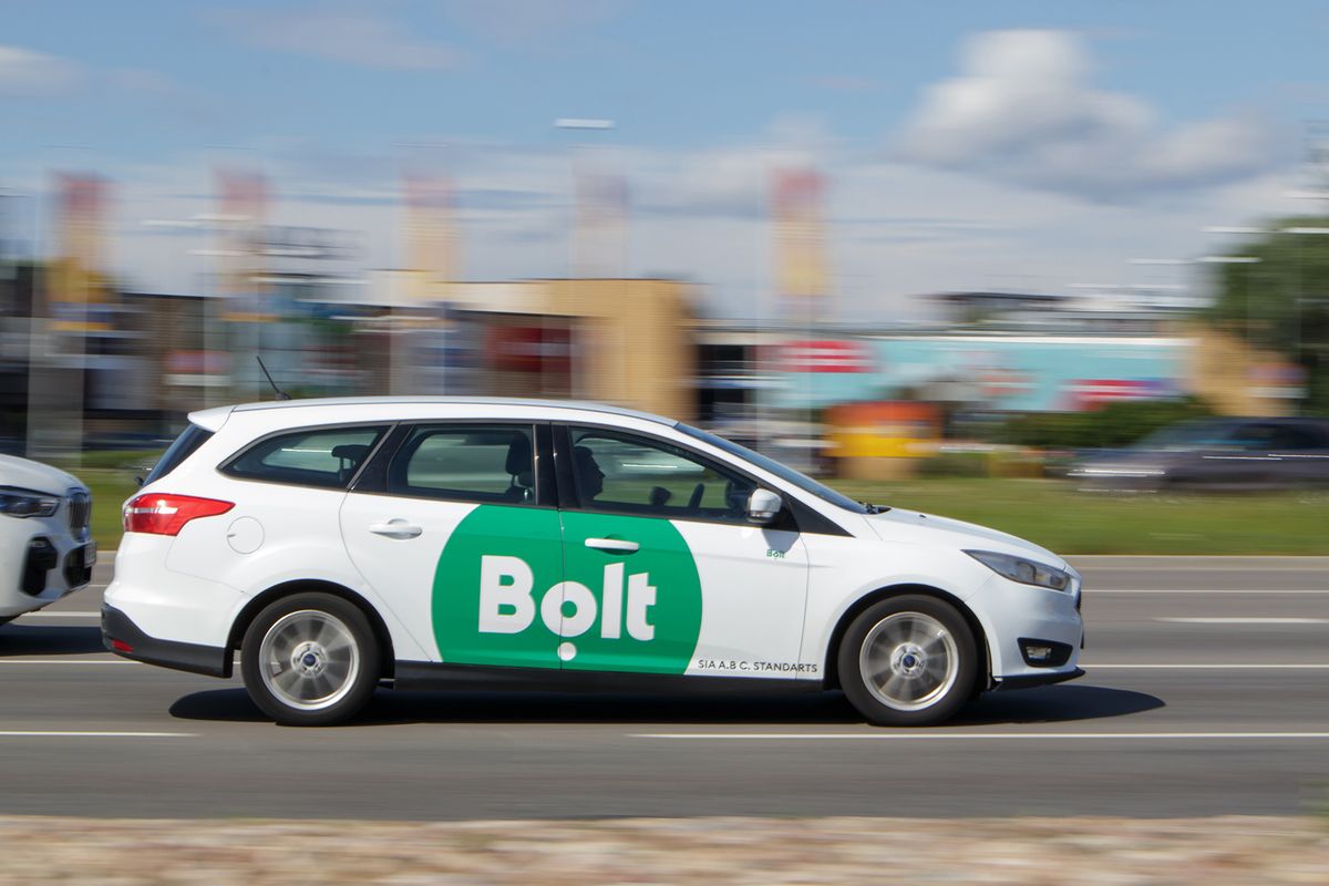 White,Bolt,Taxi,On,The,Street,In,Riga.,Motion,Blur.
White Bolt taxi on the street in Riga. Motion blur. Riga, Latvia - 28 Jun 2021.