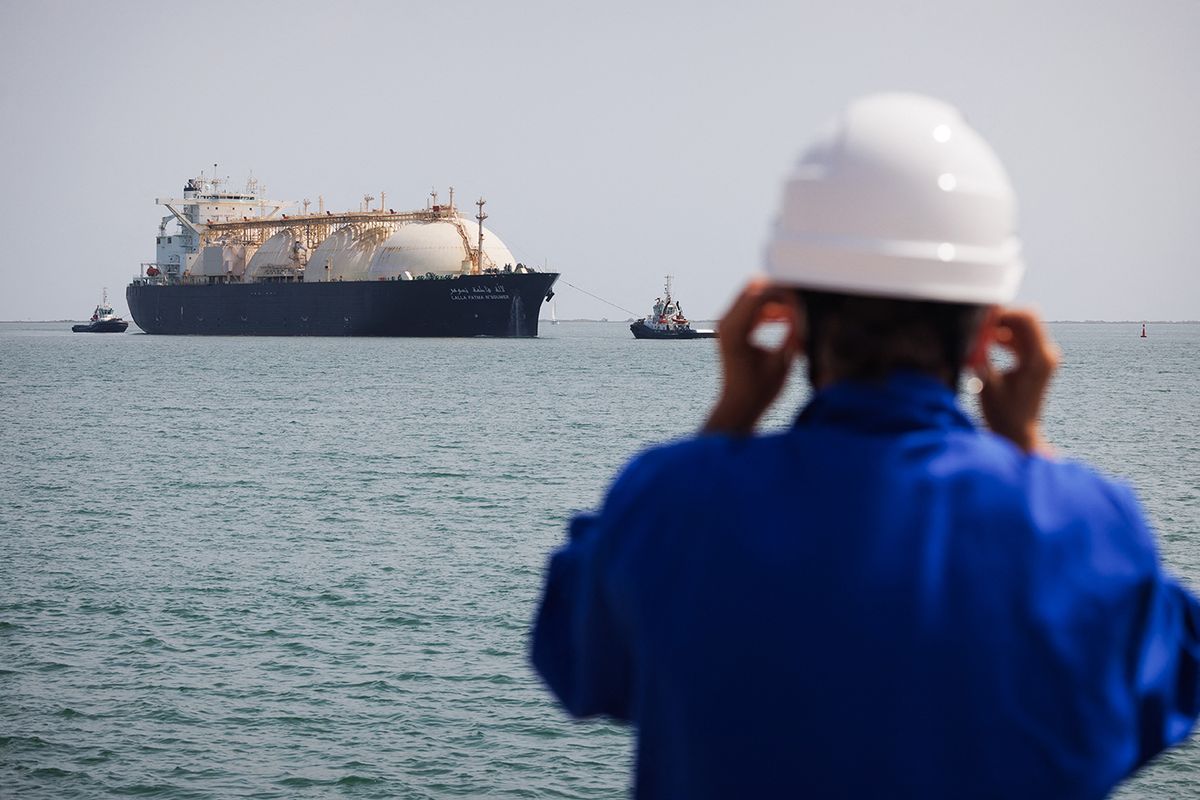 FRANCE-ENVIRONMENT-INDUSTRY-ECONOMY-ENERGY-GASThis picture shows a worker standing on the uploading dock of Cavaou LNG (Liquefied Natural Gas) terminal in Fos-sur-Mer, June 22, 2023, while the tanker boat "Lalla Fatma N'Soumer" arrives full of LNG ready to be delivered. Cavaou methane terminal, owned by Engie and operated by Elengy, subsidiary company of GRTGaz, has experienced record activity since the war in Ukraine started. Liquefied Natural Gas mainly comes from Algeria and Qatar, before being regasified there and injected into the network. 25% of the gaz consumed in France arrives here by tanker boats. (Photo by CLEMENT MAHOUDEAU / AFP)