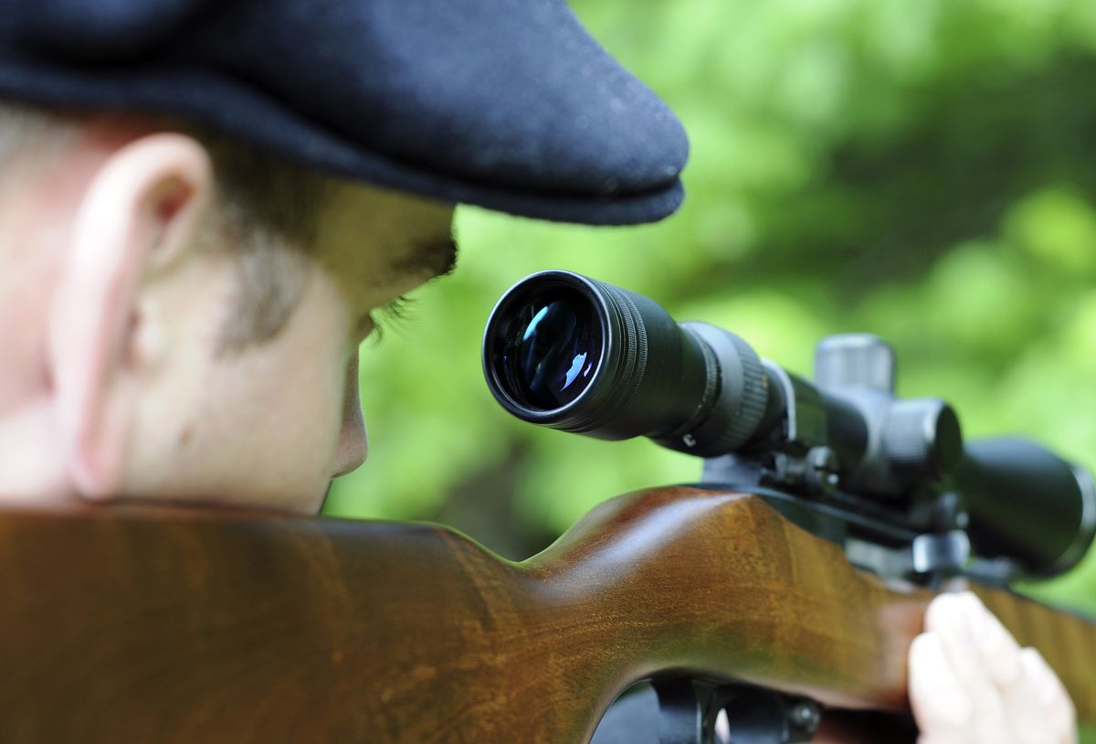 Man,Looking,Through,The,Scope,On,His,Wooden,Rifle,Gun
