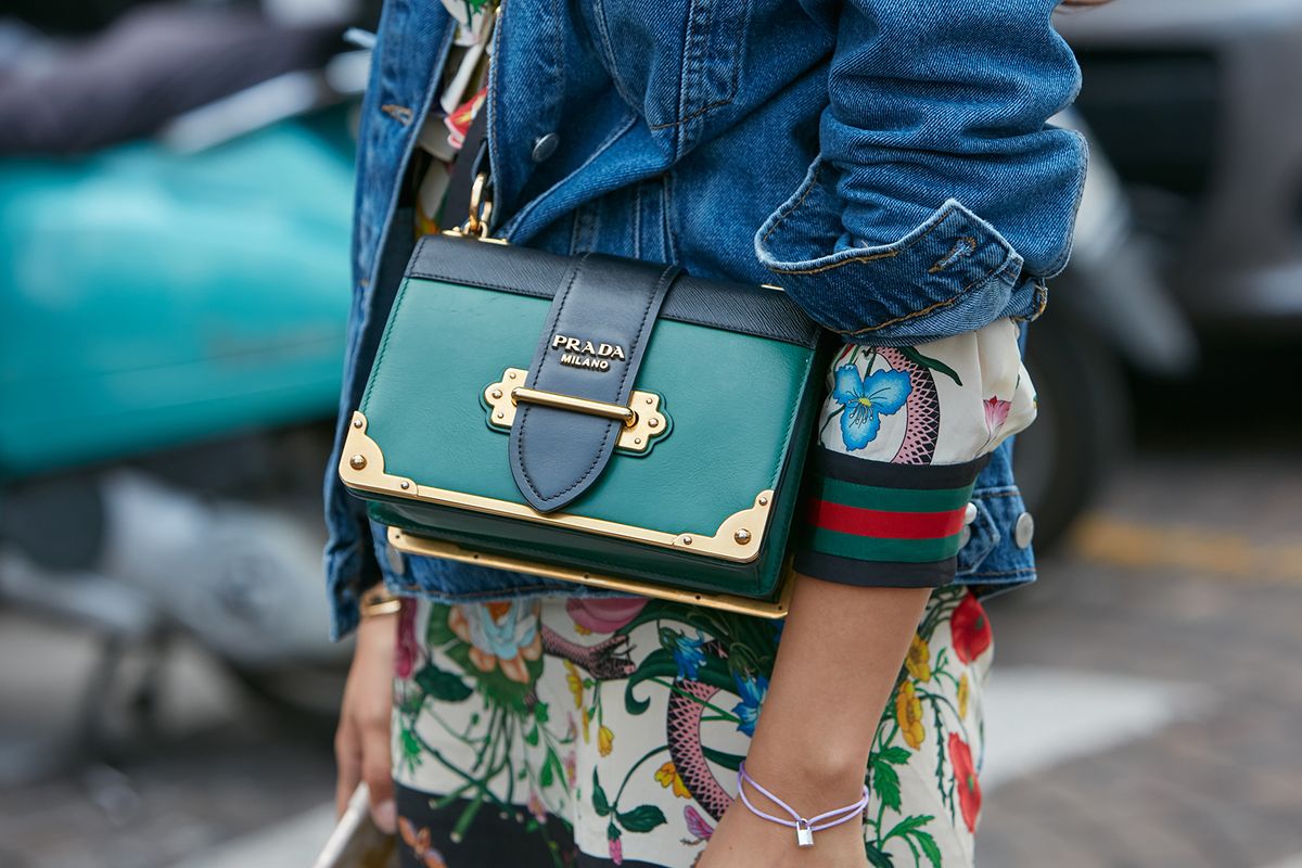 Milan,-,September,23:,Woman,With,Green,Prada,Bag,And
MILAN - SEPTEMBER 23: Woman with green Prada bag and blue jeans jacket before Antonio Marras fashion show, Milan Fashion Week street style on September 23, 2017 in Milan.