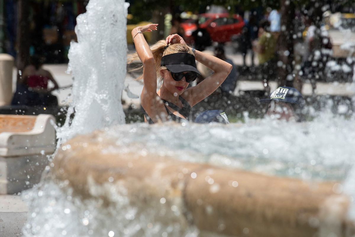 Heatwave Hits Athens, Greece
A woman tries to cool off at a fountain at Syntagma Square during a heatwave in Athens, Greece, on June 23, 2022 (Photo by Nicolas Koutsokostas/NurPhoto) (Photo by Nicolas Koutsokostas / NurPhoto / NurPhoto via AFP)