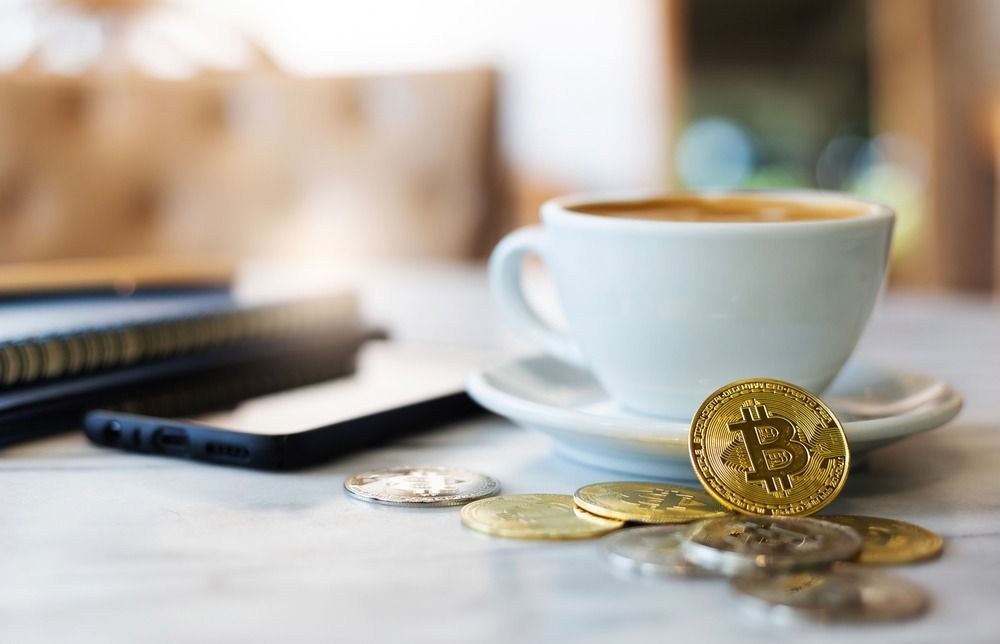 Select,Focus,On,Golden,Bitcoin,In,Front,Of,White,Coffee