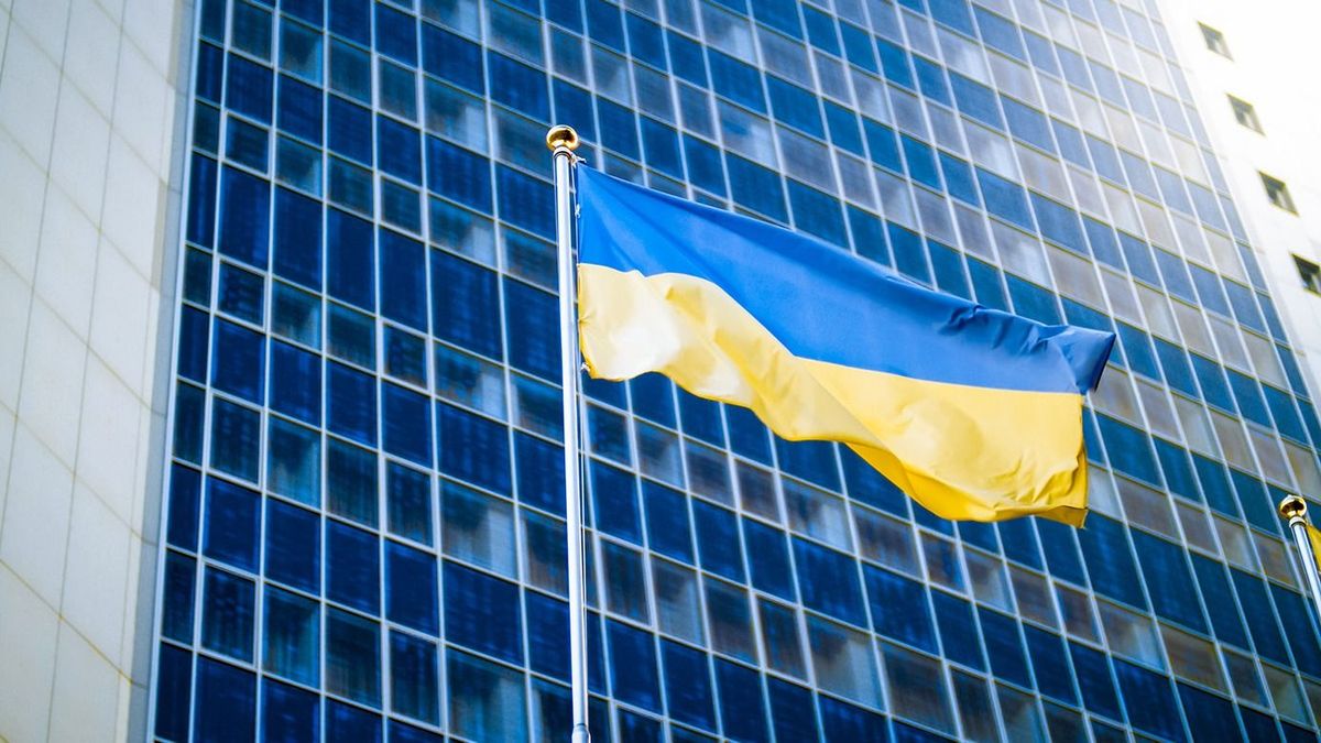 Photo,Of,Yellow,And,Blue,Ukrainian,Flag,Against,Modern,Business