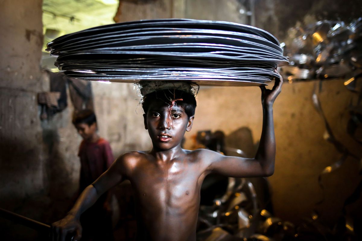 Made In BangladeshSept. 14, 2015 - Dhaka, Bangladesh - MAHIN is 10-year-old boy who works in an aluminum factory where different kinds of jars and pots are made. He lives in Dhaka with other workers of the same factory. His father is a poor farmer. Child labor still affects millions of kids worldwide. Statistics from the International Labor Organization show that there are about 73 million children between ages 10 and 14 that work in economic activities throughout the world, and 218 million children working worldwide between the ages of 5 and 17. These figures do not even include domestic labor. The child labor problem is worst in Asia, where 44.6 million children have to work. In India 14.4% of all children between the ages of 10 and 14 are employed as child laborers. In Bangladesh the number is a shocking 30.1%. Bangladesh adopted the National Child Labor Elimination Policy 2010, providing a framework to eradicate all forms of child labor by 2015, but according to the International Labor Organization there are still around 3.2 million child laborers in Bangladesh and, according to the International Labour Organization, around 215 million kids worldwide are currently working in exploitative child labour conditions. 