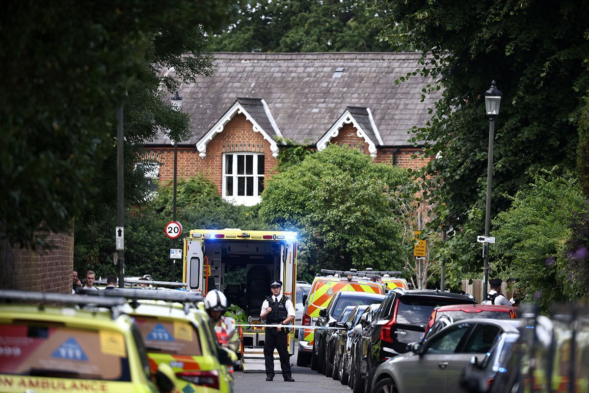 BRITAIN-POLICE-ACCIDENT
A police officer stands guard next to an ambulance behind a cordon following a car collision at the private Study Prep girls' school in Wimbledon, southwest London, on July 6, 2023. Nine people including seven children were hurt when a car collided with the primary school building in London, police said, as the local lawmaker said he understood some of those injured were "critical". (Photo by HENRY NICHOLLS / AFP)