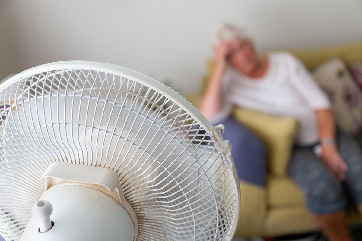 Senior,Woman,On,A,Sofa,Suffering,From,Excessive,Heat,During
Senior woman on a sofa suffering from excessive heat during a heatwave and being cooled by an oscillating electrical fan in the foreground