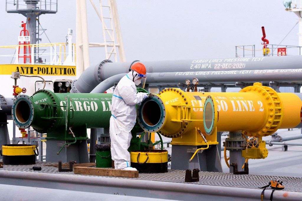 An immigration inspection officer checks an oil tanker carrying imported crude oil at Qingdao port in China's eastern Shandong province on May 9, 2022. (Photo by AFP) / China OUT