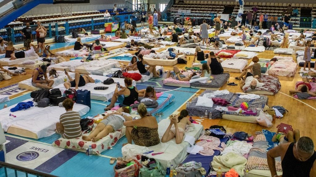Greece evacuates 19,000 as wildfires rage on Rhodes island
RHODES ISLAND, GREECE - JULY 23: People evacuated from their home take shelter at a sports hall in Venetokleio due to wildfires on Rhodes island, Greece on July 23, 2023. Some 19,000 people have been evacuated from the Greek island of Rhodes as wildfires continued burning for a sixth day, authorities said on Sunday. As many as 266 firefighters and 49 fire engines were on the ground battling the blazes, assisted by five helicopters and 10 airplanes. Damianidis Eleftherios / Anadolu Agency (Photo by Damianidis Eleftherios / ANADOLU AGENCY / Anadolu Agency via AFP)