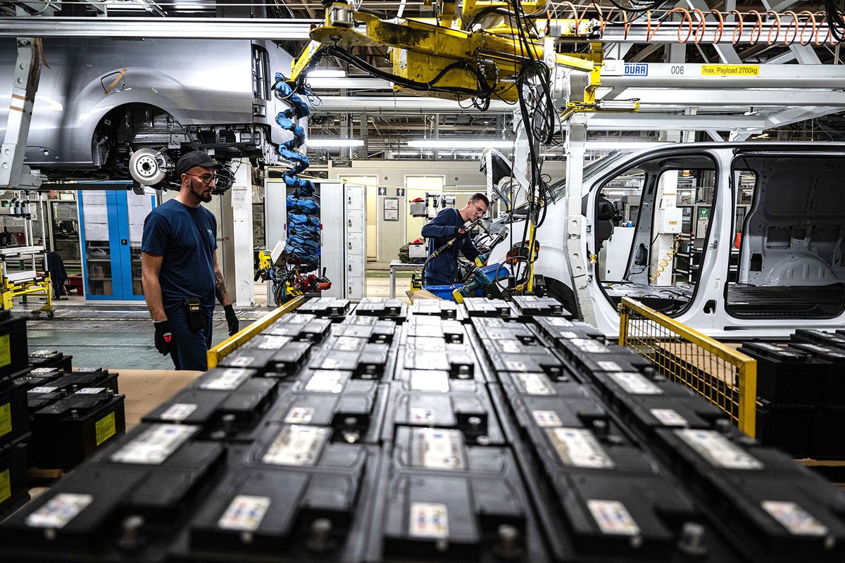 Operators work at the assembly workshop of the Stellantis cars factory in Hordain, northern France on October 27, 2022. The Stellantis group, born from the merger of PSA and Fiat-Chrysler, will launch the mass production of hydrogen-powered commercial vehicles in its factory located in Hordain, northern France, the carmaker's CEO, Carlos Tavares, announced on October 27, 2022. (Photo by Sameer Al-DOUMY / AFP)