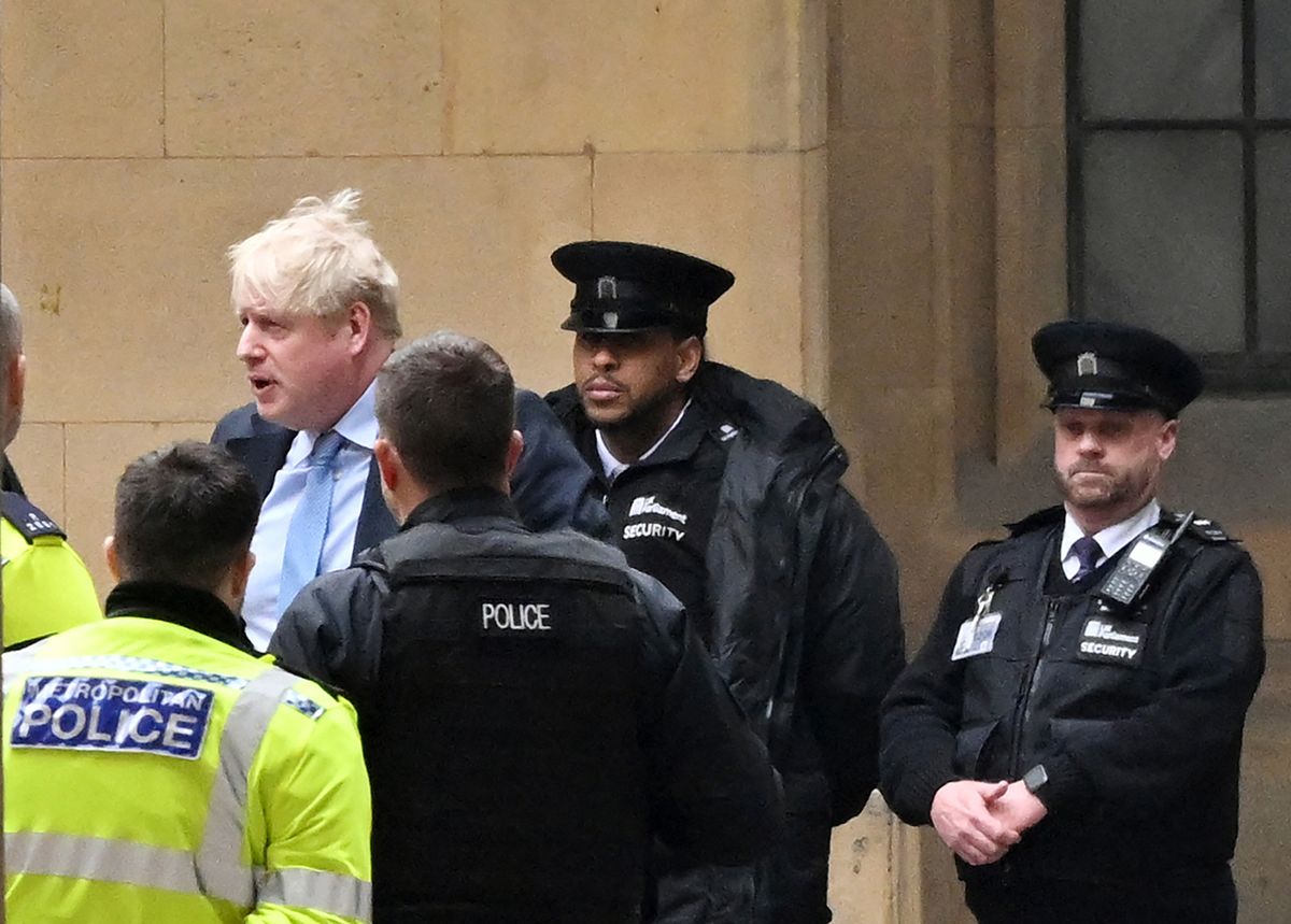 BRITAIN-POLITICS-JOHNSONFormer British Prime Minister Boris Johnson walks through the Parliamentary Estate on his way to Portcullis House in central London on March 22, 2023, to attend Parliament's Privileges Committee hearing. Britain's former prime minister Boris Johnson re-entered the bear pit of parliamentary inquisition on Wednesday for a grilling about "Partygate" that could decide his political future. (Photo by JUSTIN TALLIS / AFP)