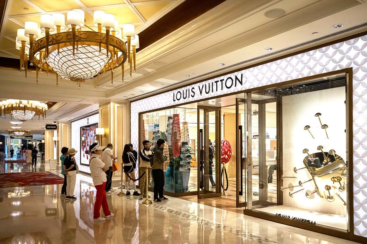 A photo taken on March 9, 2023 shows visitors queuing outside a Louis Vuitton shop at the Wynn hotel resort in Macau.
