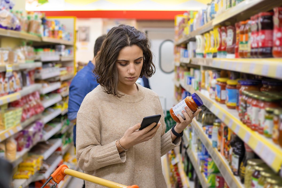 Focused,Woman,Using,Smartphone,In,Grocery,Store.,Young,Woman,Reading
Focused woman using smartphone in grocery store. Young woman reading checklist via smartphone and choosing products in grocery store. Supermarket concept