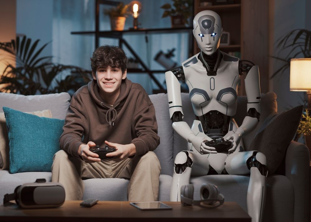 Happy,Teenager,And,Ai,Robot,Sitting,On,The,Couch,At