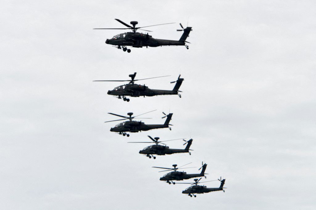 (FILES) US-made AH-64E Apache attack helicopters fly in formation during the annual Han Kuang military drills in Taichung on July 16, 2020. The United States on August 21, 2023, approved a $12 billion sale of Apache attack helicopters to Poland, a giant deal with a frontline ally supporting Ukraine in its war against Russian invasion. The State Department said in a statement that it notified Congress of approval for the sale requested by the Polish government, which would include 96 AH-64E Apache attack helicopters. (Photo by Sam Yeh / AFP)