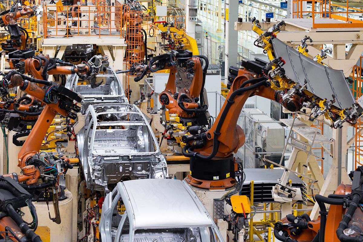 Car bodies are on assembly line. Factory for production of cars. Modern automotive industry. Top of view