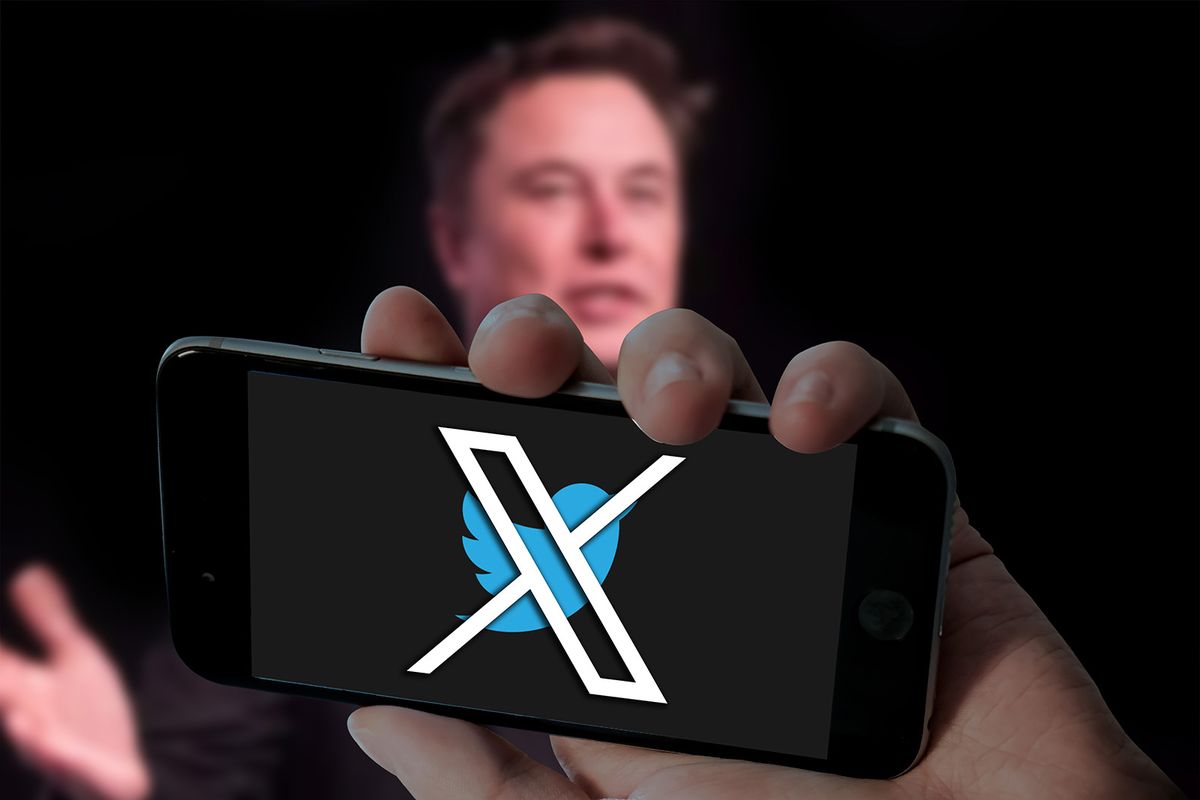 CHENNAI, INDIA, 24TH JULY 2023: Twitter X with bird logo in holding mobile and Elon musk picture in blurred laptop screen background.