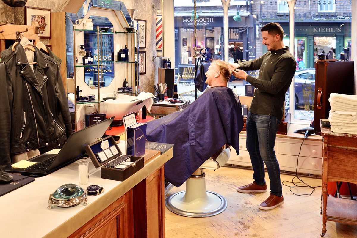 UNITED KINGDOM. ENGLAND. LONDON. SEVEN DIALS DISTRICT. CLIENT HAVING A HAIRCUT AT THE BARBER AND HAIRDRESSER MURDOCK. (Photo by ANTOINE LORGNIER/ ONLWORLD.NET / ONLY WORLD / Only France via AFP)