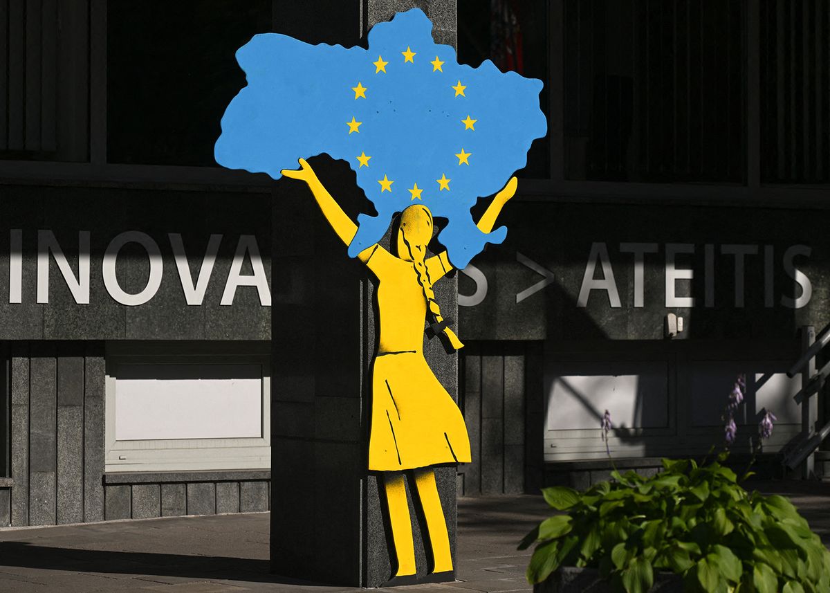 Daily Life In Vilnius
VILNIUS, LITHUANIA - JUNE 12, 2023:   Street art depicting a young woman carrying the outlines of a map of Ukraine with the European flag inside, inVilnius, Lithuania, in Vilnius, Lithuania, on July 12, 2023. (Photo by Artur Widak/NurPhoto) (Photo by Artur Widak / NurPhoto / NurPhoto via AFP)