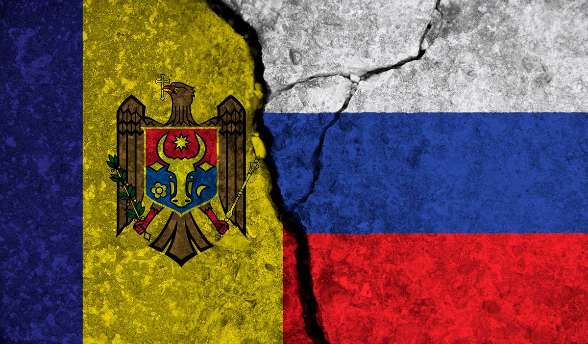 Political relationship between Moldova and russia. National flags on cracked concrete background