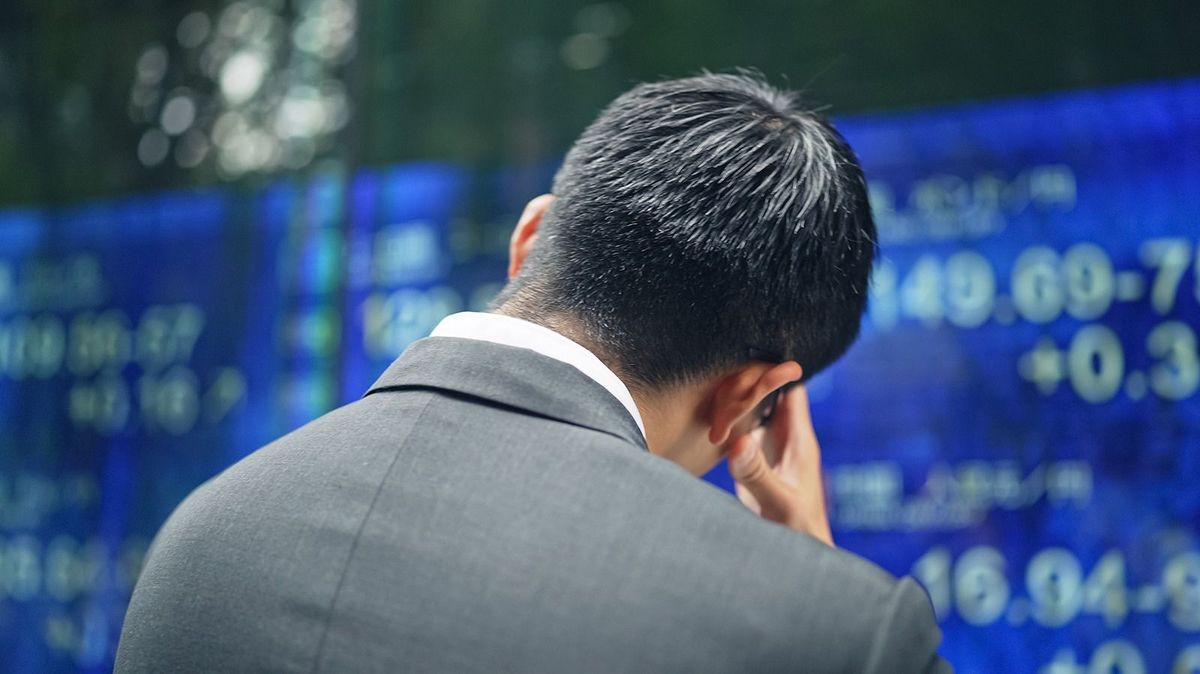 Depressed,Businessman,In,Front,Of,An,Electric,Bulletin,Board.