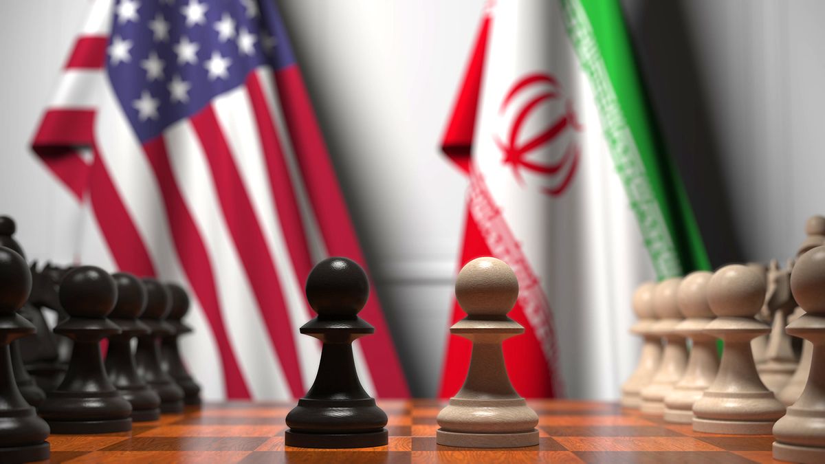 Flags,Of,United,States,And,Iran,Behind,Chess,Board.,The, Flags of United States and Iran behind chess board. The first pawn moves in the beginning of the game. Political rivalry conceptual 3D rendering