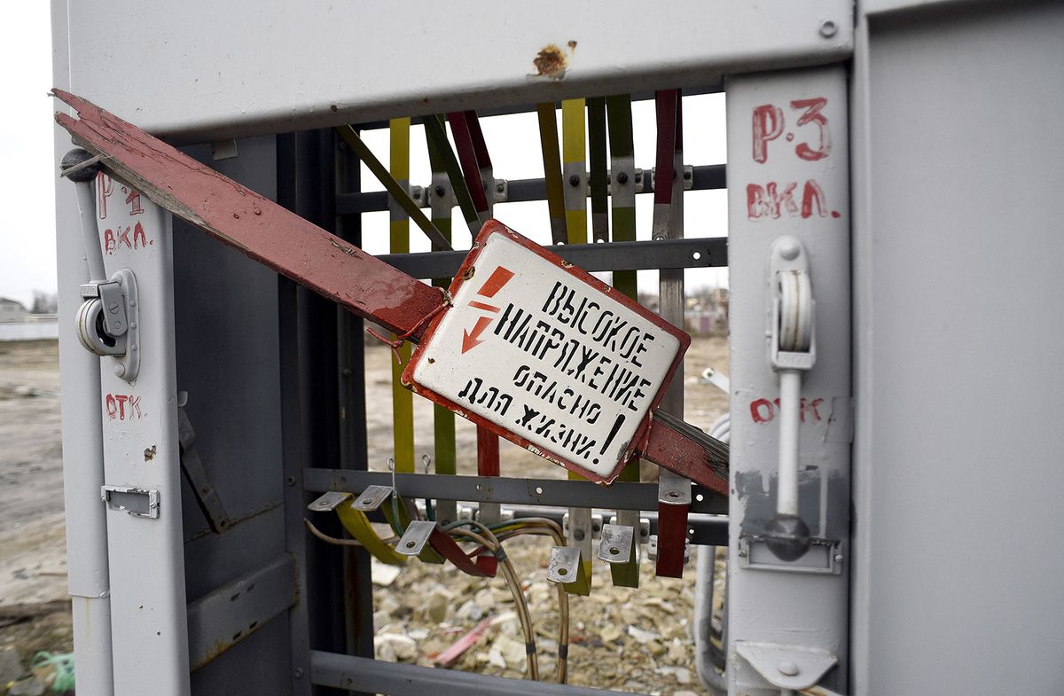IZIUM, UKRAINE - DECEMBER 25, 2022 - The 'High Voltage' warning sign stays on a destroyed transformer in Izium liberated from Russian occupiers, Kharkiv Region, northeastern Ukraine. NO USE RUSSIA. NO USE BELARUS. (Photo by Kaniuka Ruslan / NurPhoto / NurPhoto via AFP)