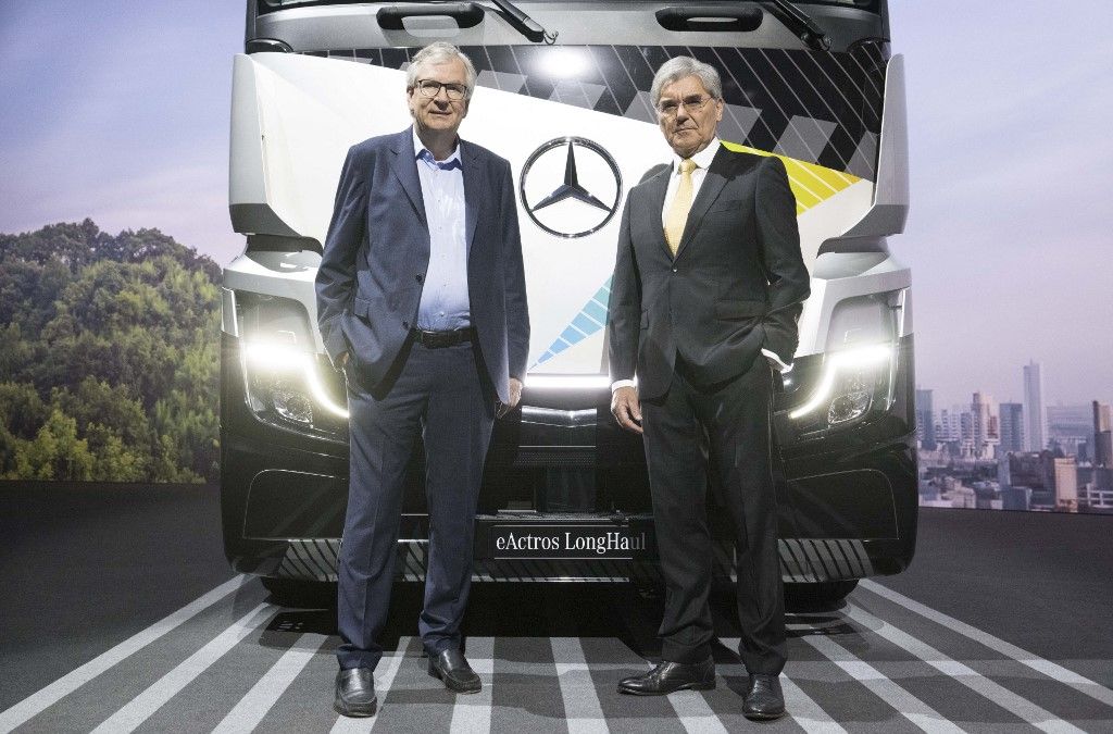 Martin Daum (L), CEO of Daimler Truck Holding AG, and Joe Kaeser, chairman of the supervisory board, pose in front of an eActros truck at the company's annual general meeting in Stuttgart, southern Germany, on June 21, 2023. (Photo by THOMAS KIENZLE / AFP)