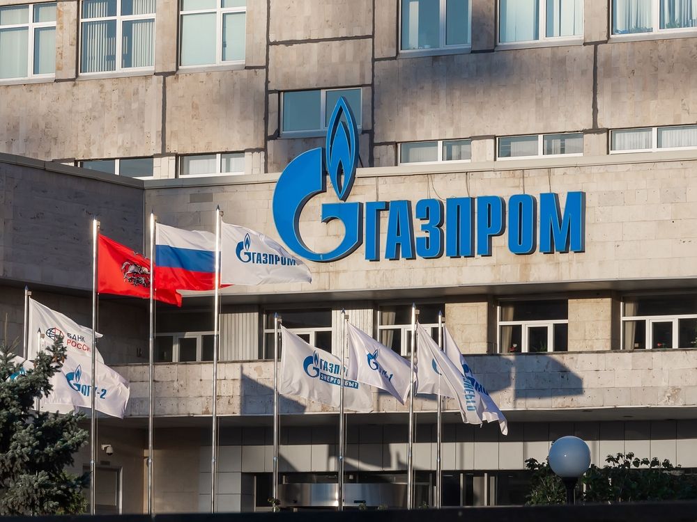 Gazprom,Logo,On,The,Building,Facade,And,Corporate,Flags,Waving