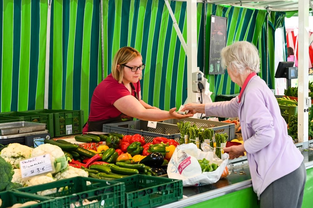 Ulm,,Germany,,May,2022:,A,Woman,Buys,Fresh,Vegetables,At