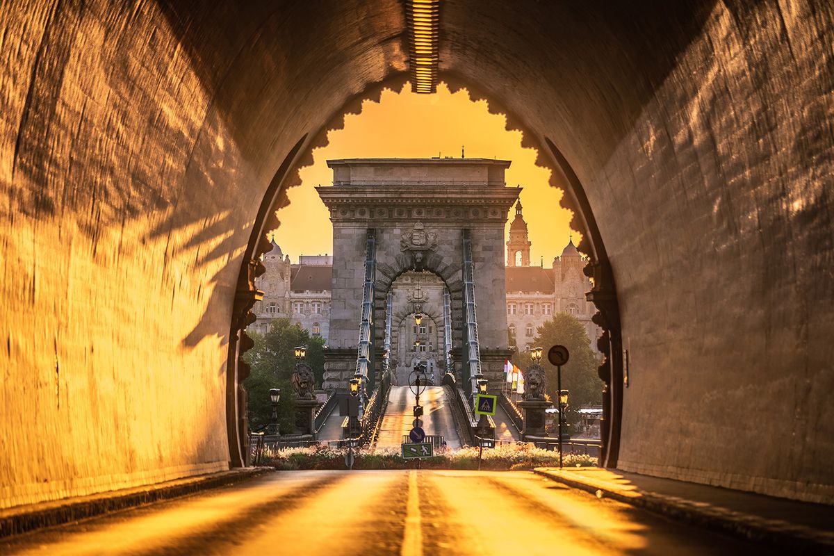 Budapest,,Hungary,-,Entrance,Of,The,Buda,Castle,Tunnel,At
Budapest, Hungary - Entrance of the Buda Castle Tunnel at sunrise with Szechenyi Chain Bridge and Academy of Science  building at background