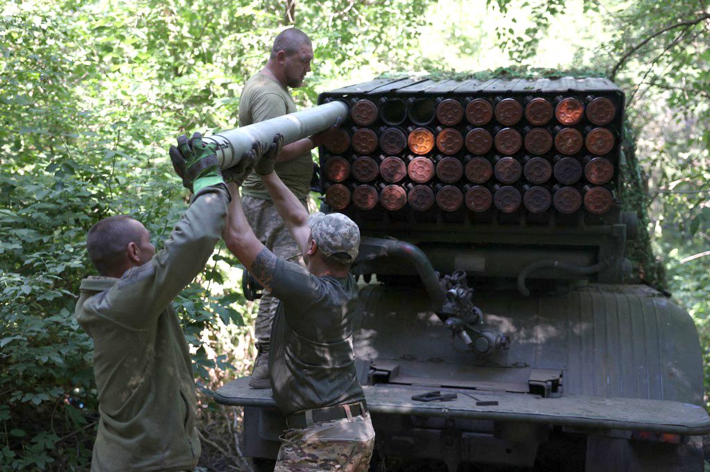 Ukrainian artillerymen load missiles onto a self-propelled 122 mm multiple rocket launcher BM-21 "Grad" near Bakhmut, Donetsk region, on July 13, 2023. (Photo by Anatolii Stepanov / AFP)