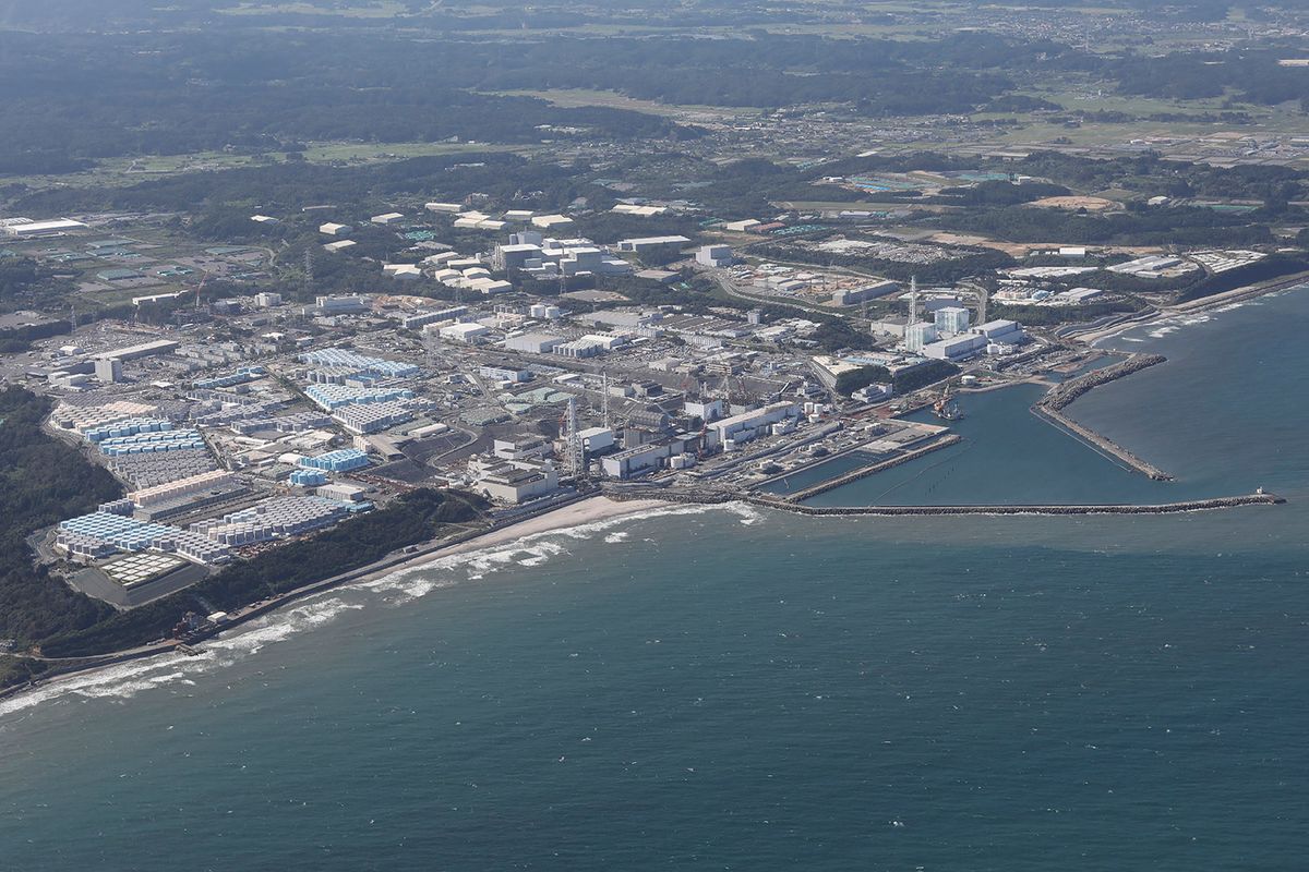 This aerial picture shows storage tanks (L) used for storing treated water at TEPCO's crippled Fukushima Daiichi Nuclear Power Plant in Okuma, Fukushima prefecture on August 24, 2023. Japan began releasing wastewater from the crippled Fukushima nuclear plant into the Pacific Ocean on August 24 despite angry opposition from China and local fishermen. (Photo by JIJI PRESS / AFP) / Japan OUT