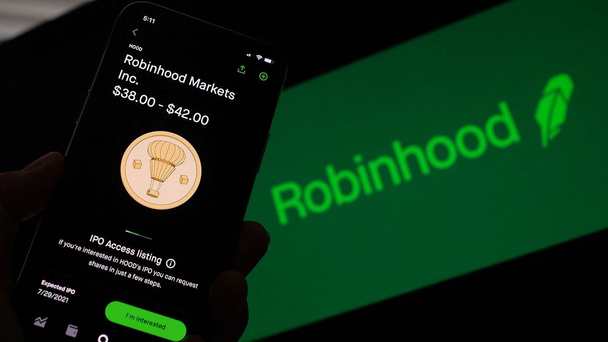 This photo illustration shows a person looking at a smartphone with the projected Robinhood (HOOD) price shares in Los Angeles, July 27, 2021. The fast-growing online investment platform Robinhood aims for a valuation of as much as $35 billion when it goes public, the company said on July 19, 2021 in a securities filing. Robinhood, which has grown quickly during the coronavirus pandemic, anticipates offering shares at between $38 and $42 apiece, making its initial public offering worth as much as $2.3 billion.The service, which is especially popular with younger investors, has described its mission as "to democratize finance for all." (Photo by Chris DELMAS / AFP)